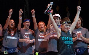 Young kid celebrates with Penn State Students at THON