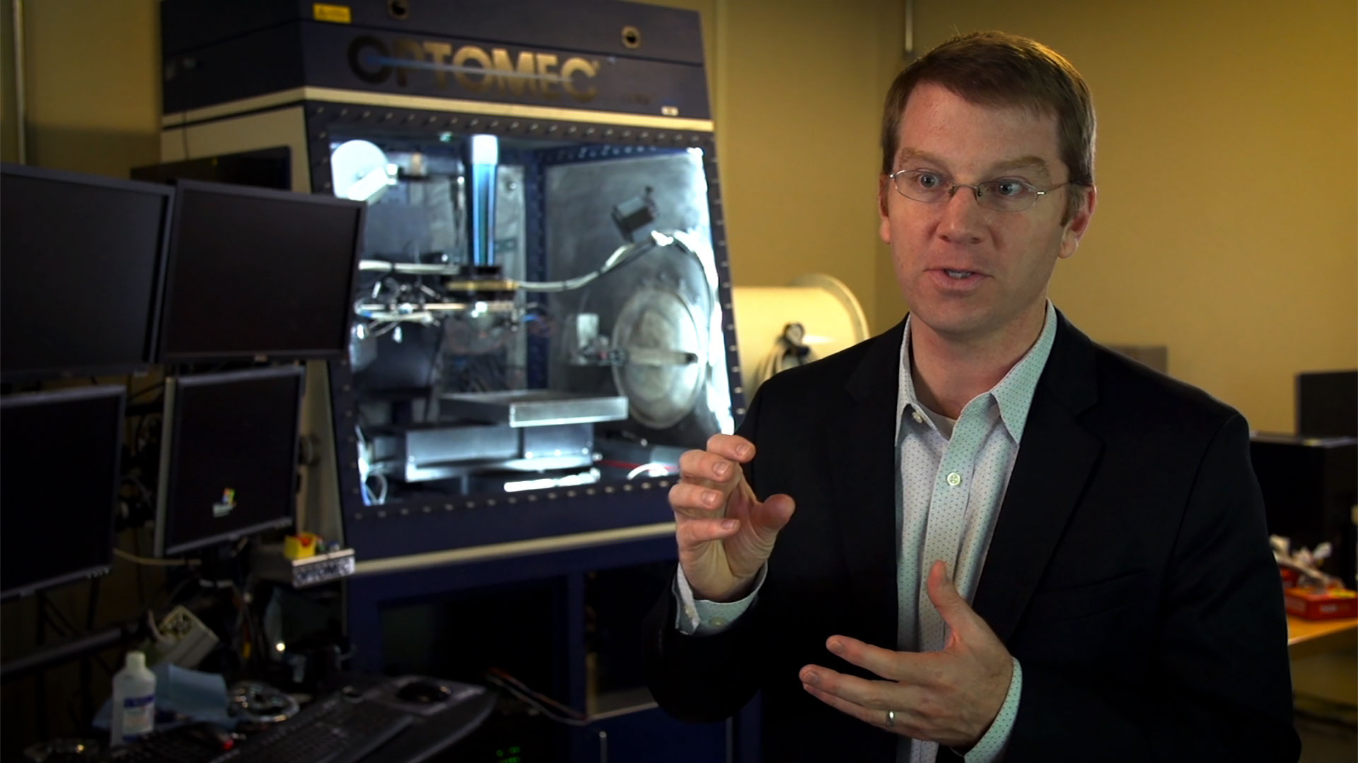 person sitting in front of 3D printer