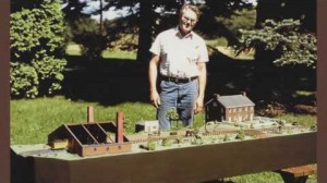 Man standing with model town