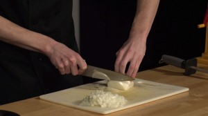 knife cutting through an onion.