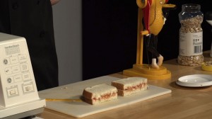 peanut butter and jelly sandwich on cutting board.