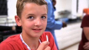 Young boy holding PTC paper