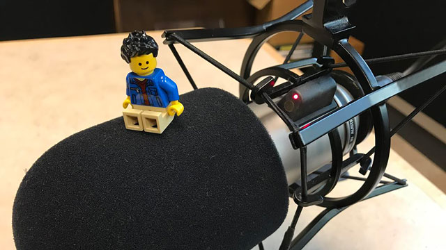 lego minifigure sitting on radio microphone