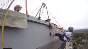 person rappelling of side of building