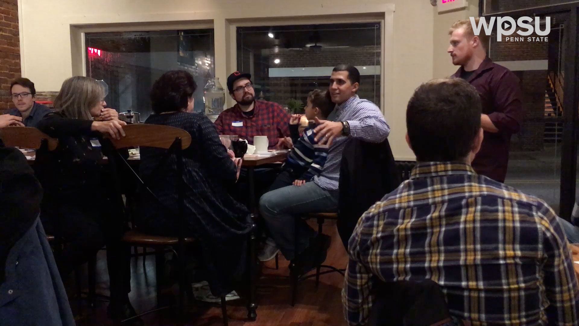 people sitting at a table in restaurant