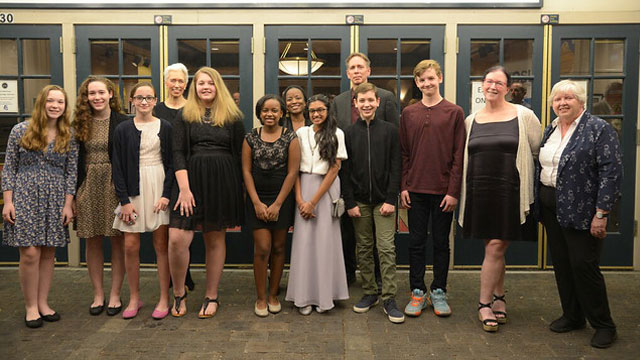 Finding Your Roots: The Seedlings cast posing for group photo in front of the State Threatre