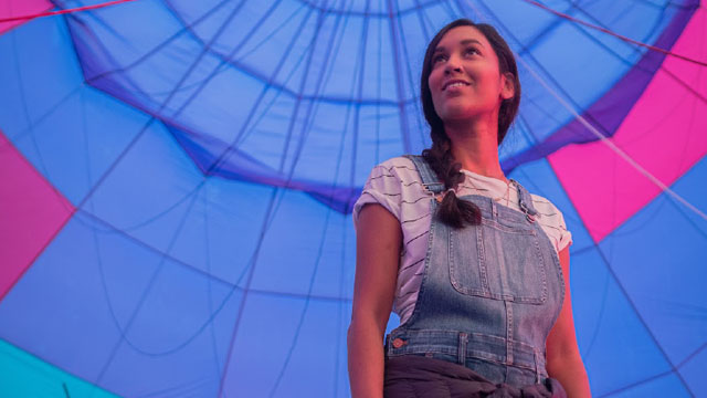 woman standing under hot air balloon