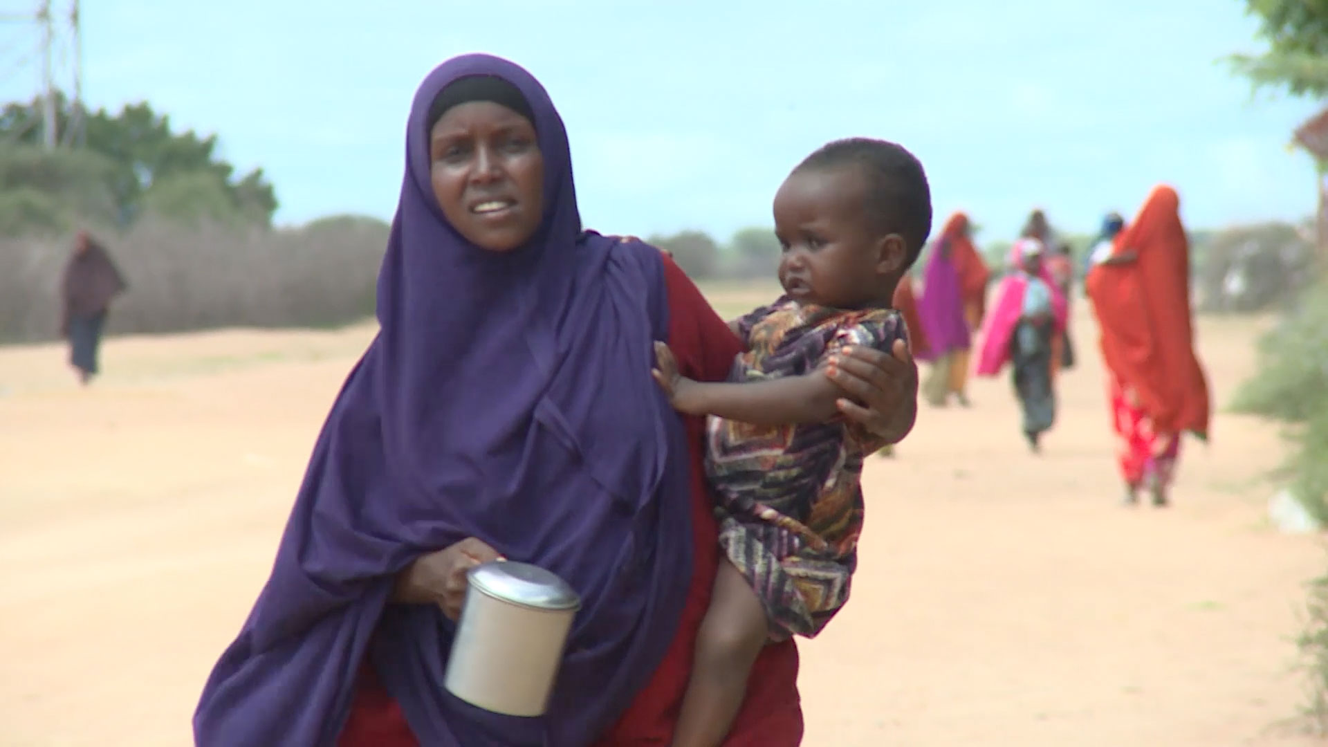 woman carrying child