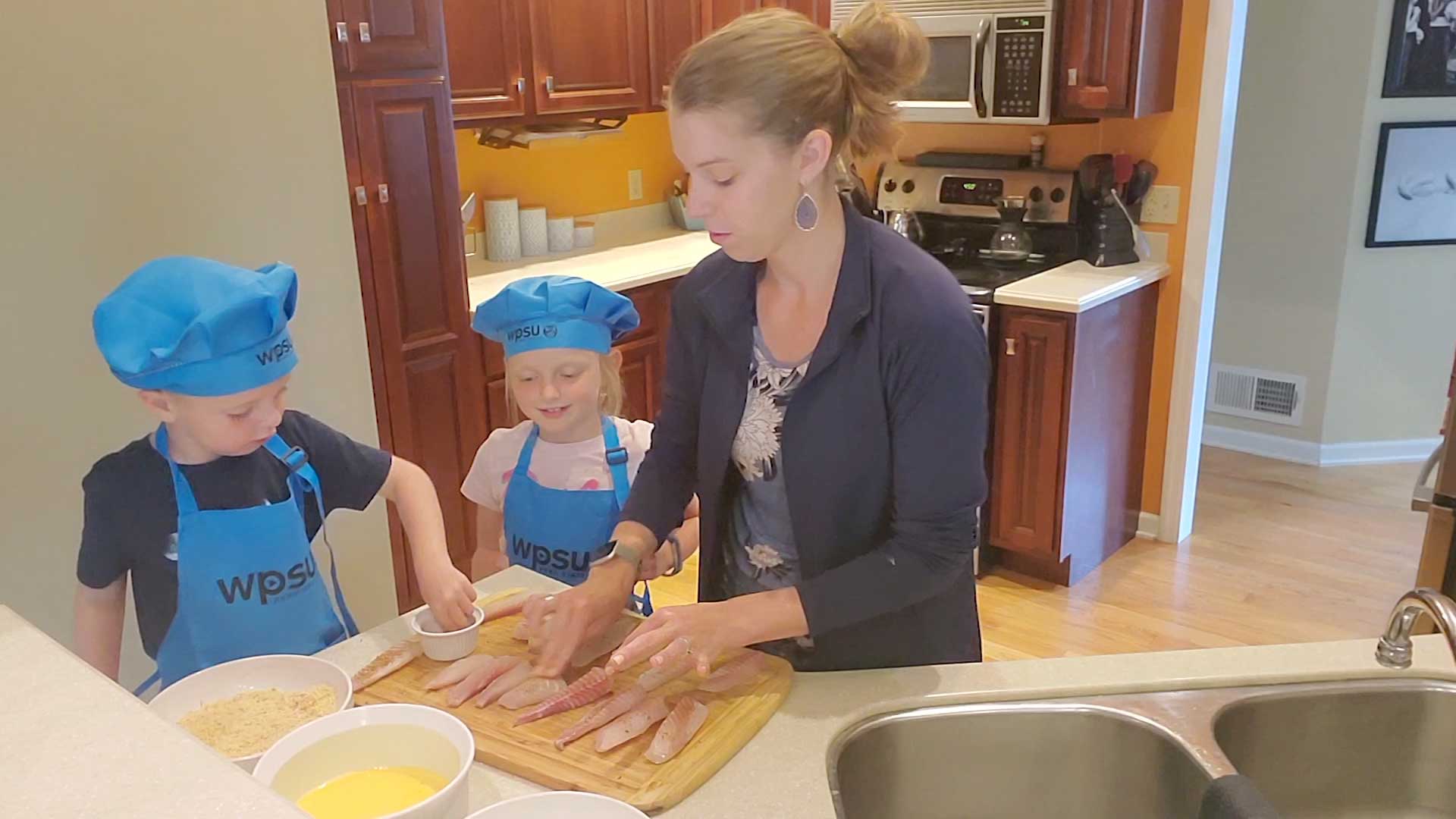 Cassie and kids making fish-sticks