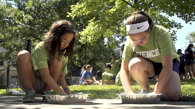 two girls making casts of their hands