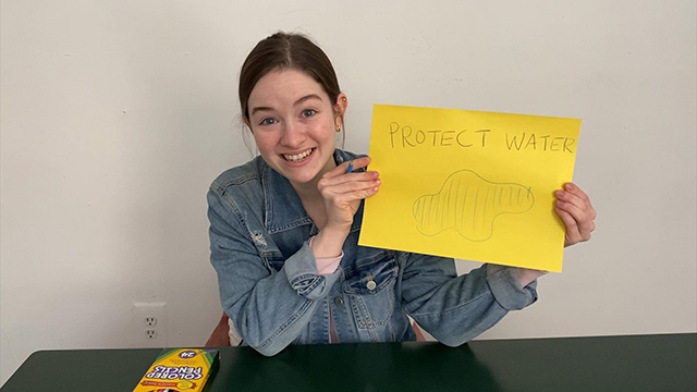 woman holding a sign
