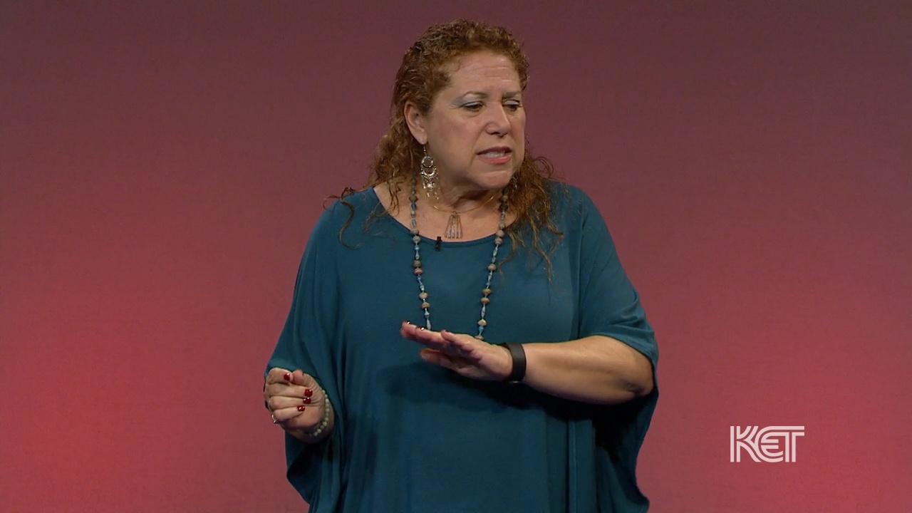 A woman in blue telling a story