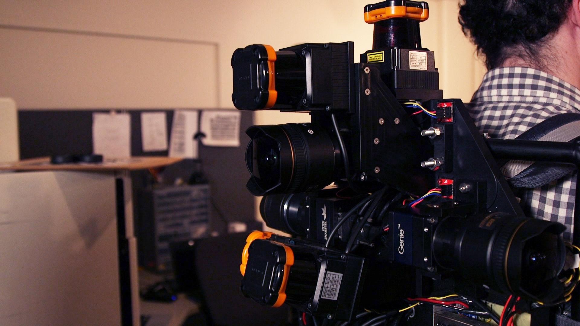 A person carrying a back harness with many cameras pointing in all directions