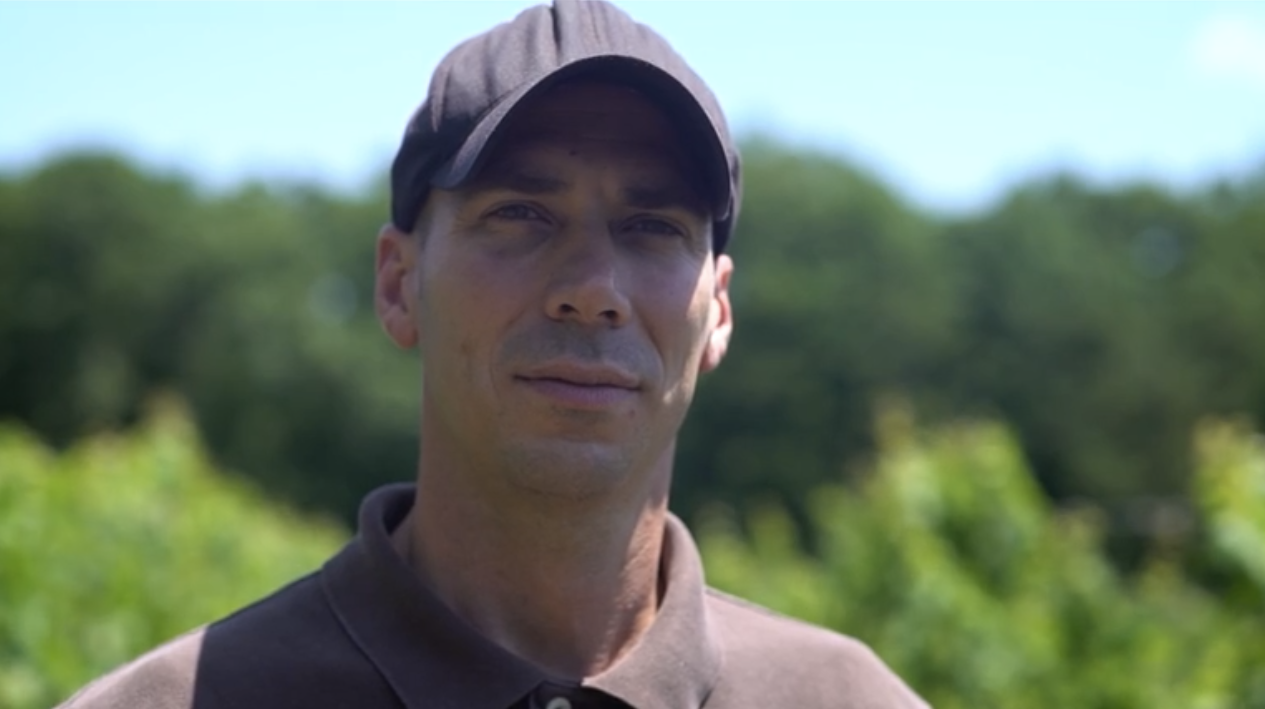A man standing in front of a winery