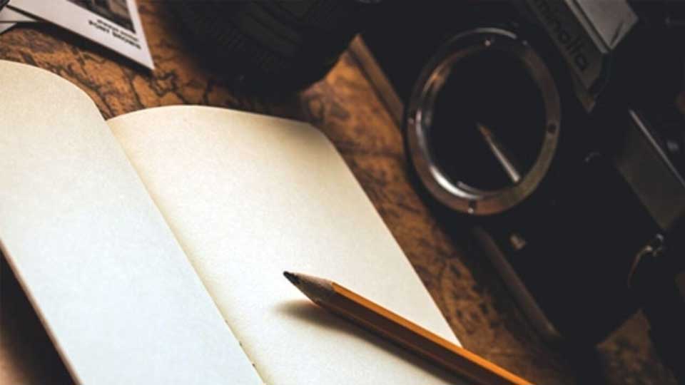 open blank journal with pencil