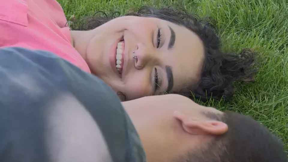 smiling woman laying on grass