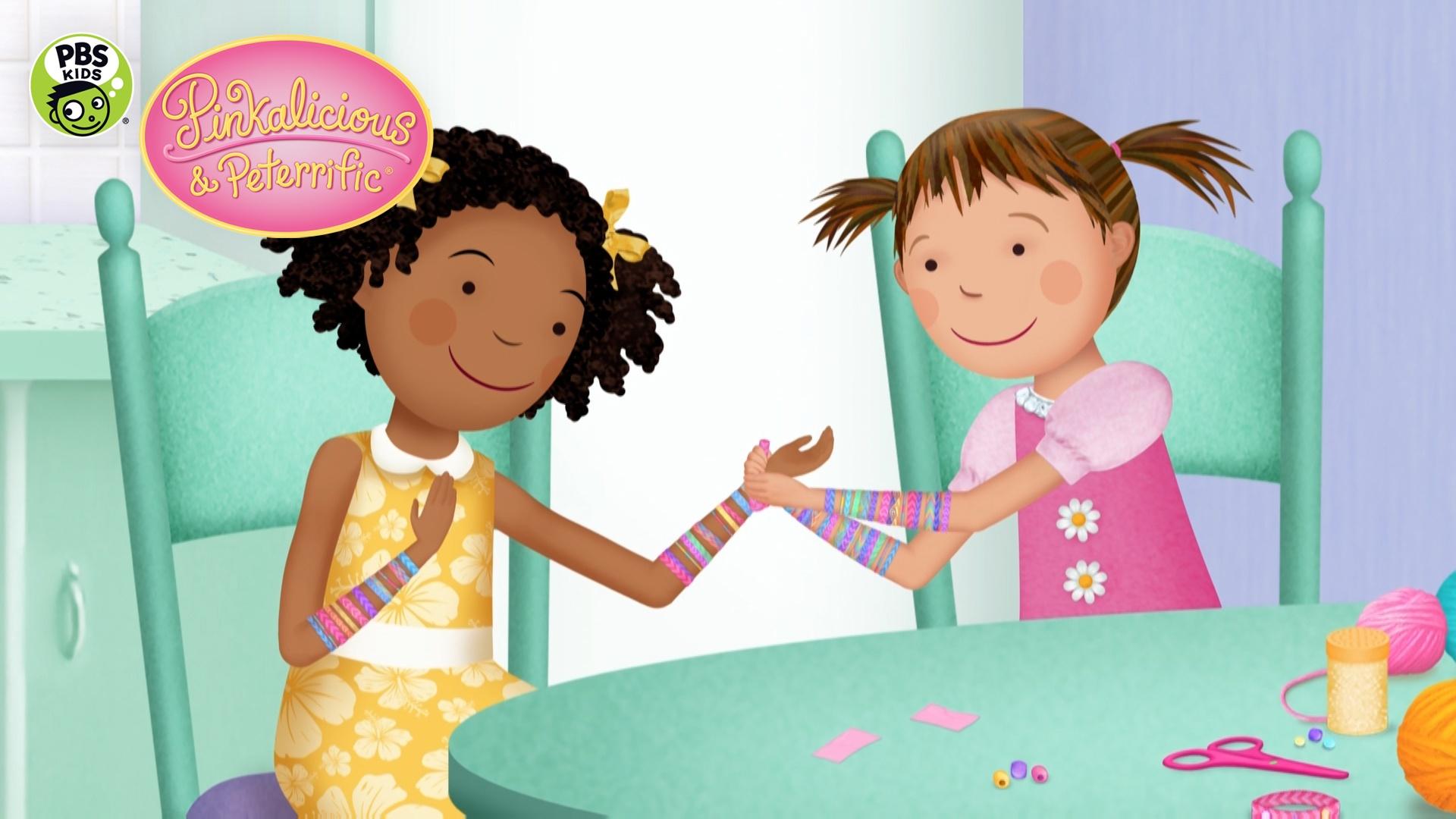 One black girl and one white girl putting on bracelets