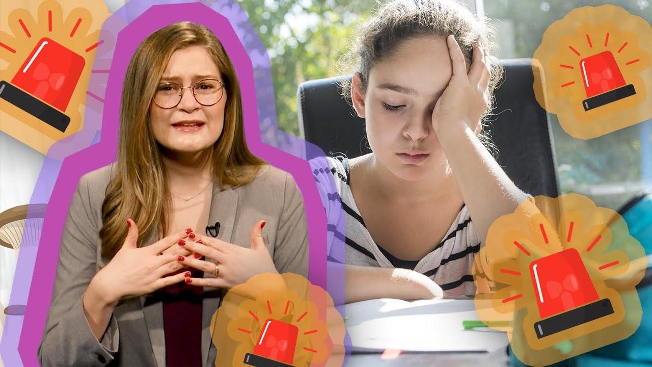 A girl presenting in front of another girl who has her hand on her head.