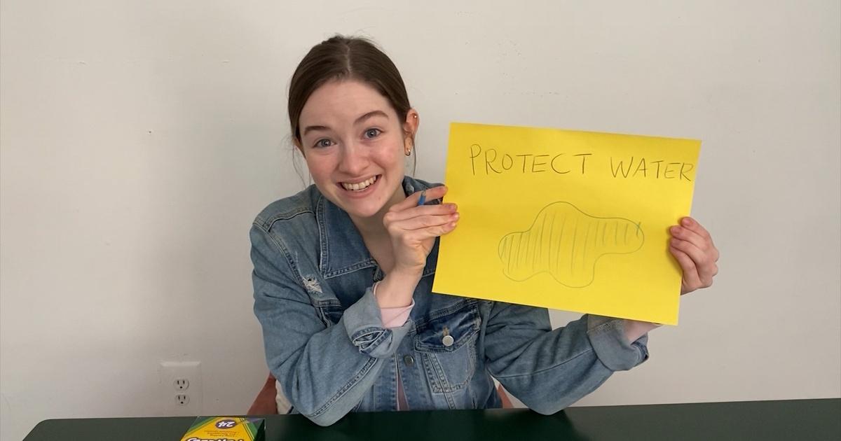 A woman holding a drawing of water