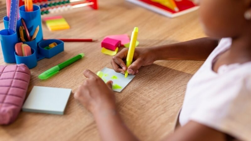 A girl drawing a weekly planner.