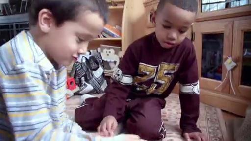 Two boys playing on the floor