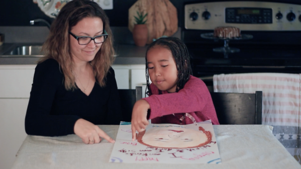 A woman and girl drawing a self portrait