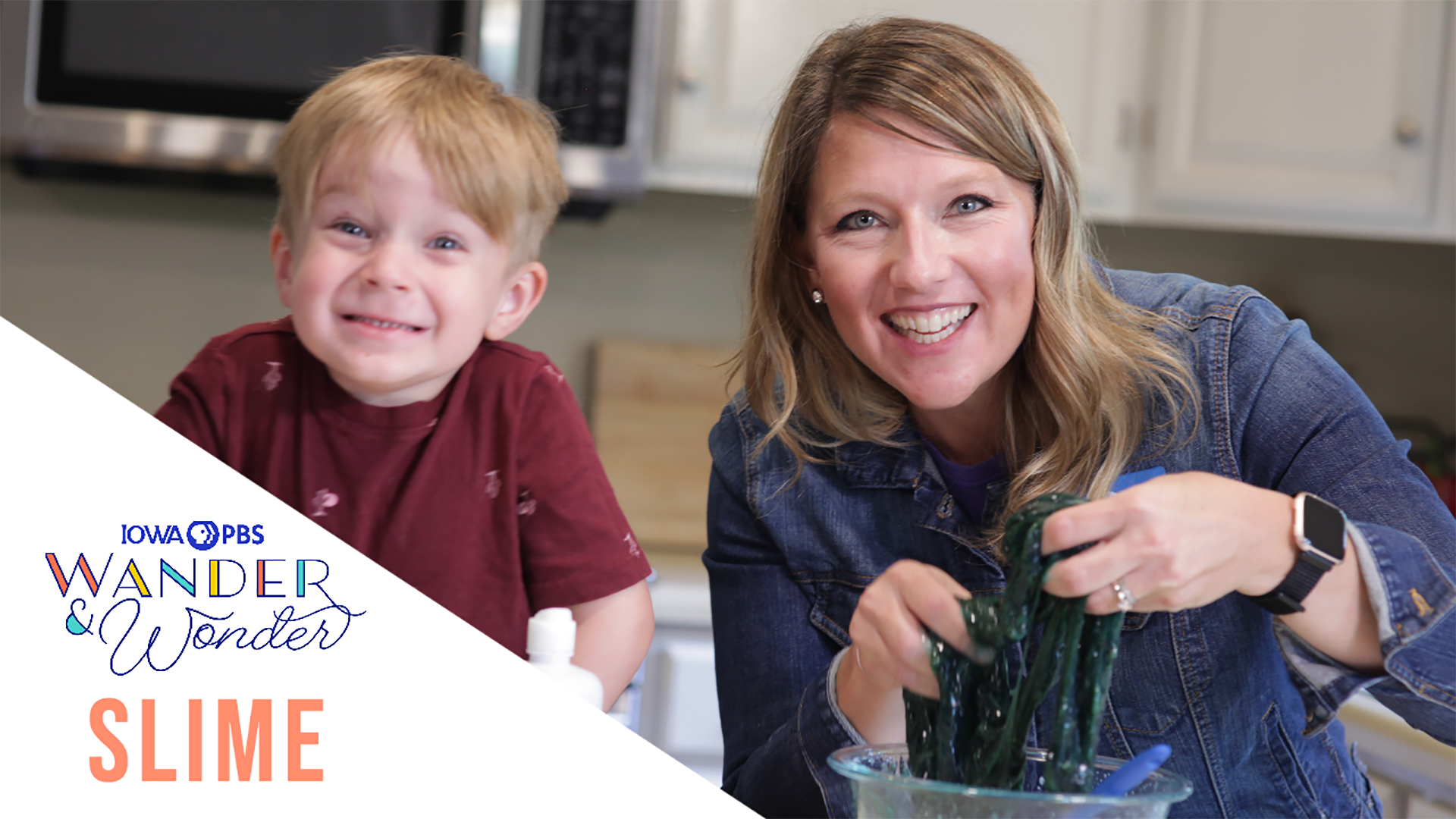 A woman and small boy making slime in a glass bowl.