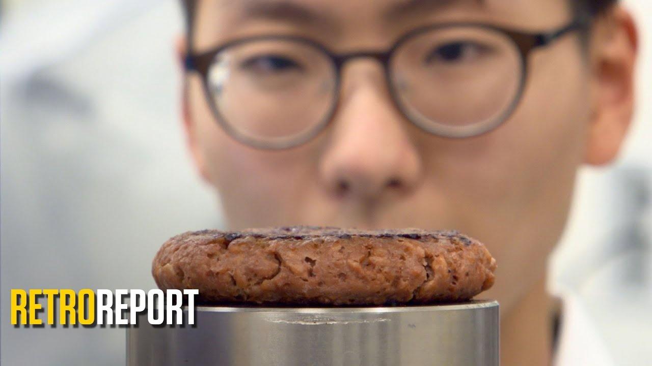 A man standing behind a plant-based meat substitute.