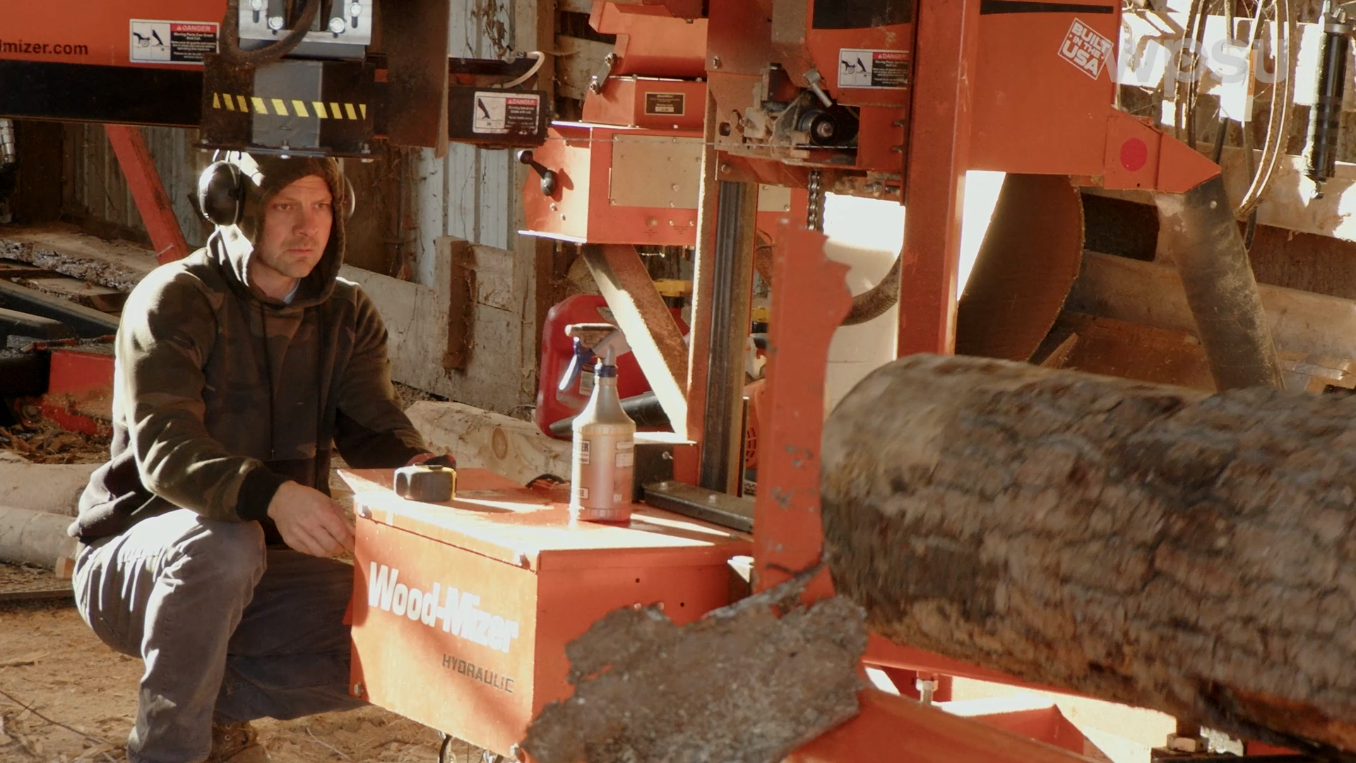 Brian Spicher operating a saw.