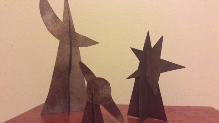 Three figurines representing the moon, a planet, and a star.