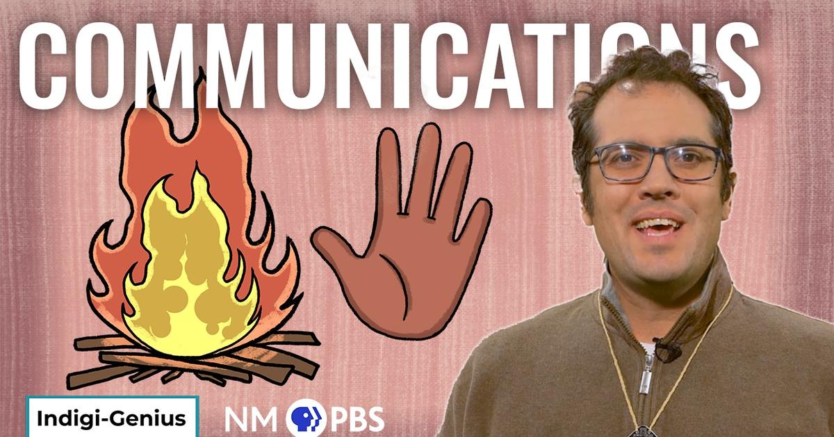 A man in glasses stands in front of a red graphic.