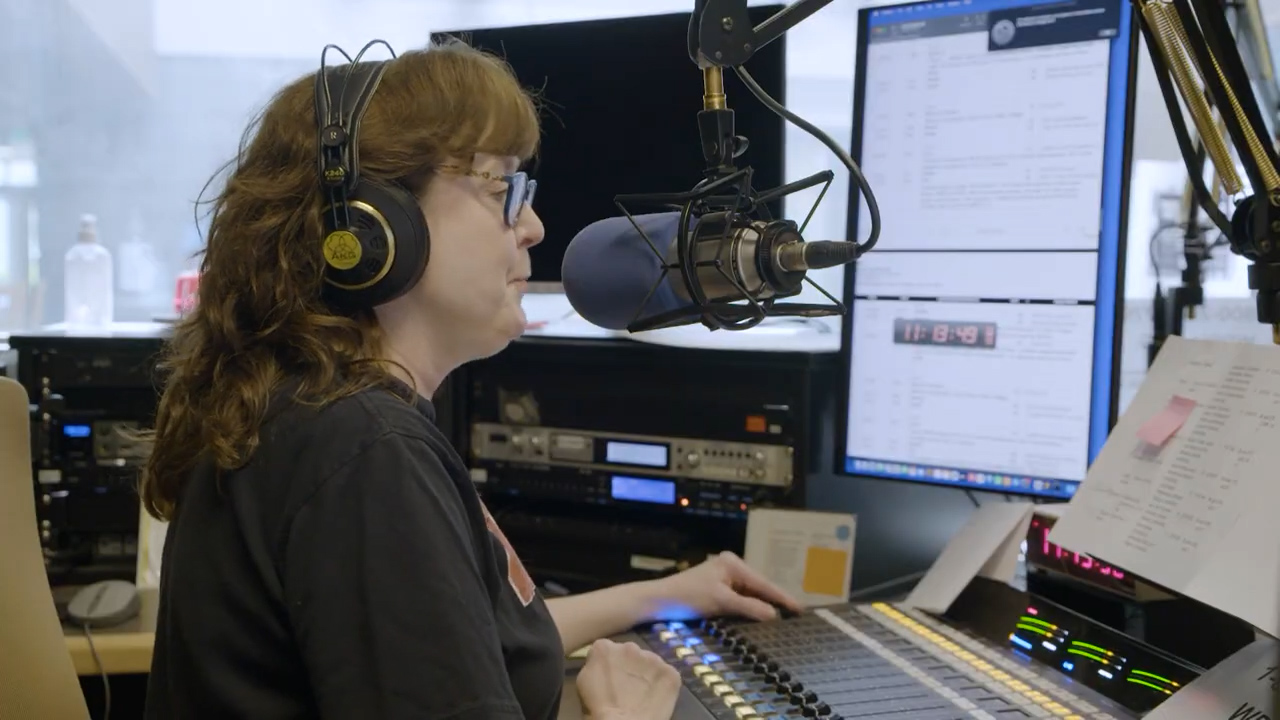 WPSU's Kristine Allen in a radio recording booth.