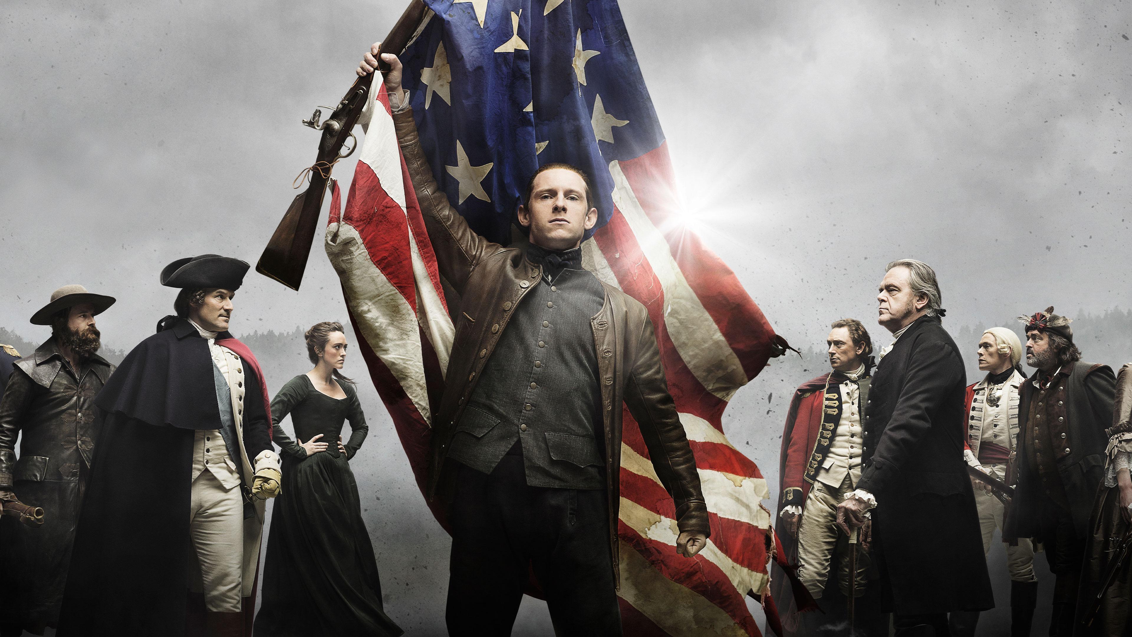 Man in revolutionary war period attire holding up American flag.