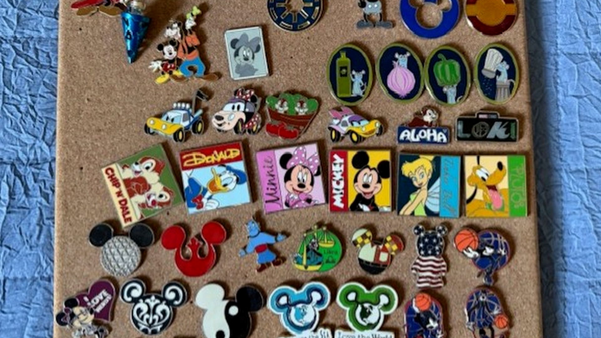 A collection of commemorative pins from Walt Disney World.
